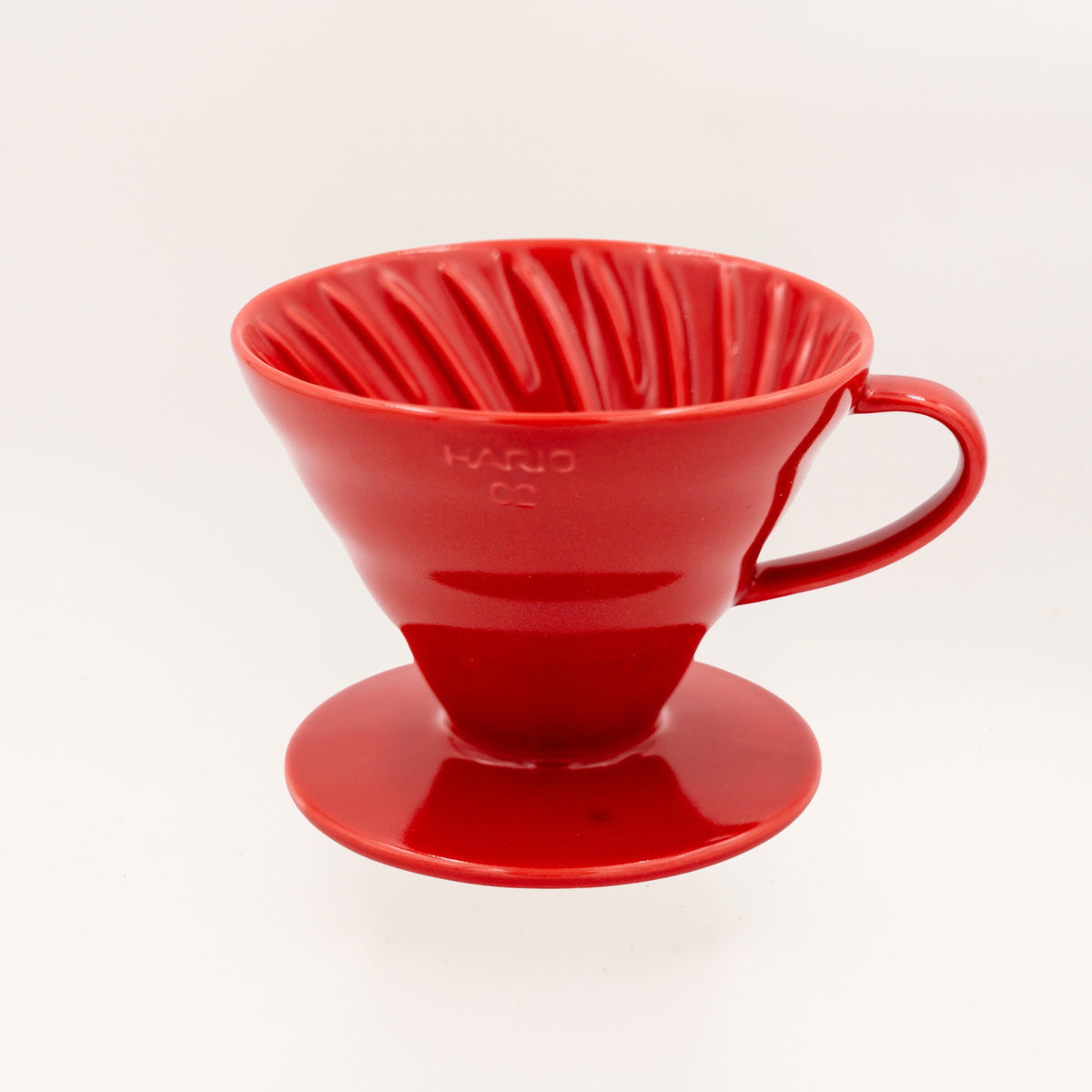 A bright red ceramic pour-over coffee Hario dripper shown on a clean white background.